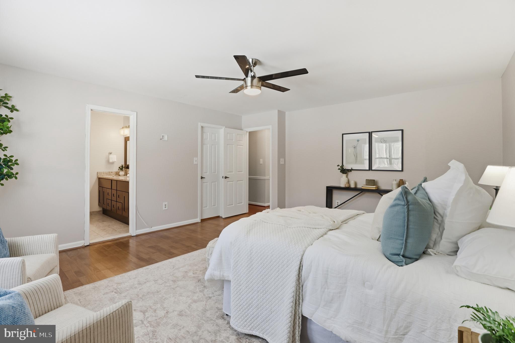 14740 Locustwood Lane Silver Spring, MD 20905 - Photo 21 of 46 a spacious bedroom with a bed and ceiling fan