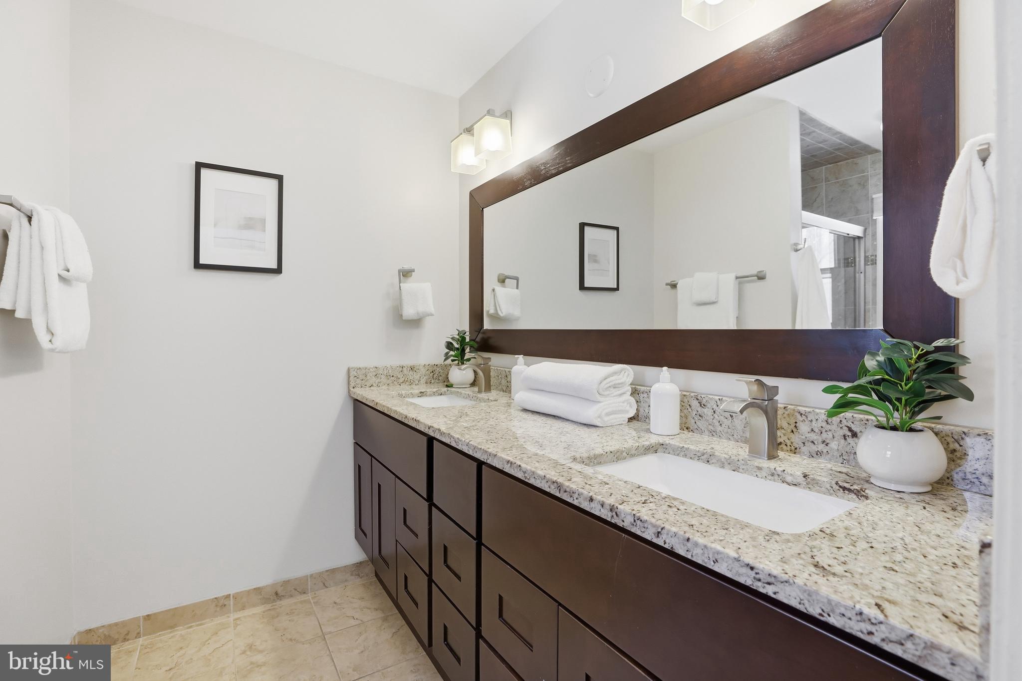 14740 Locustwood Lane Silver Spring, MD 20905 - Photo 22 of 46 a bathroom with a granite countertop sink and a mirror