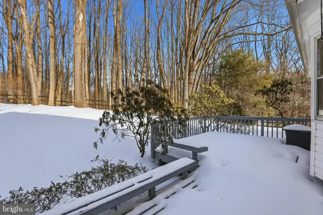 a view of balcony with wooden fence and trees