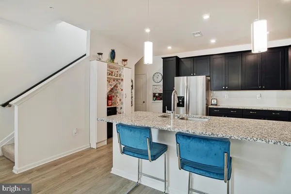 a kitchen with a stove sink and cabinets