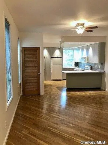 a view of a kitchen with furniture and wooden floor