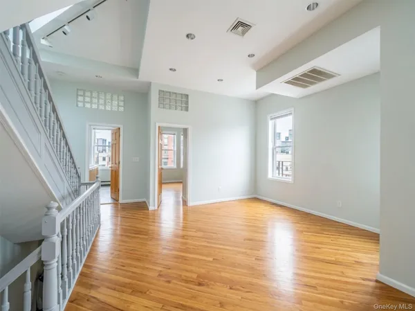 a view of an entryway with wooden floor