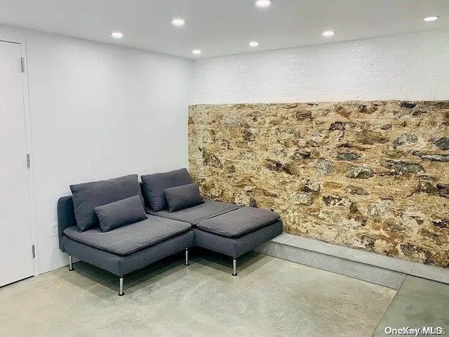 a living room with a couch and a rug