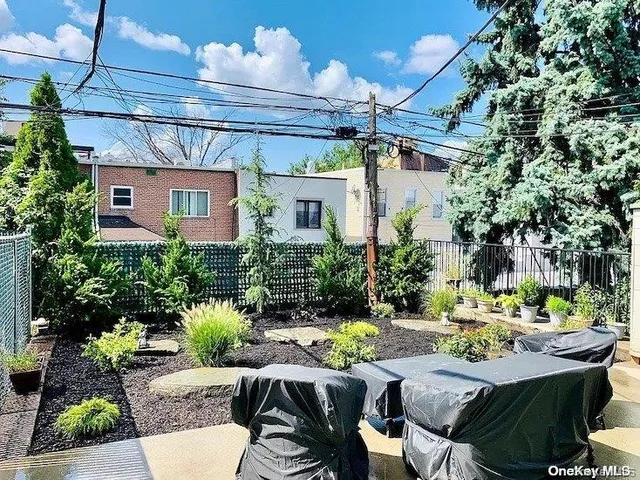 a view of a patio with table and chairs and potted plants