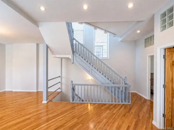 a large kitchen with kitchen island a large counter top and stainless steel appliances