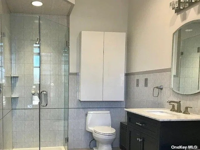 a bathroom with a sink a toilet and a mirror