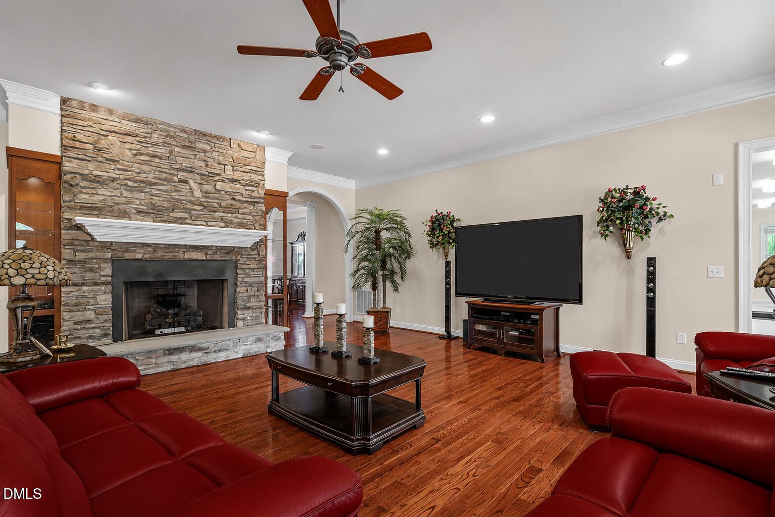 10917 Jordan Road Raleigh, NC 27603 - Photo 15 of 58 a living room with furniture a fireplace and a flat screen tv