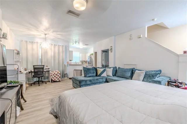 a kitchen with a refrigerator sink and cabinets
