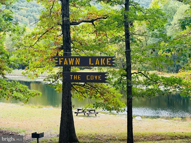 a sign that is sitting in front of a lake