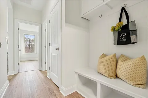 a view of hallway with wooden floor and stairs