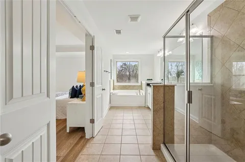 a kitchen with a refrigerator and white cabinets