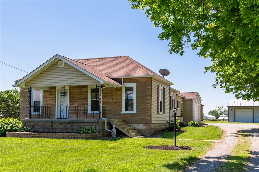 1217 Jasper Road Xenia, OH 45385 - Photo 2 of 62 This charming residence features a classic facade with a welcoming front porch and detached garage.