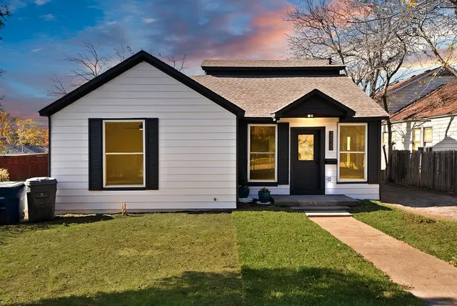 a front view of house and yard with green space