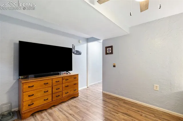 a room with flat screen tv on dresser and a flat screen tv