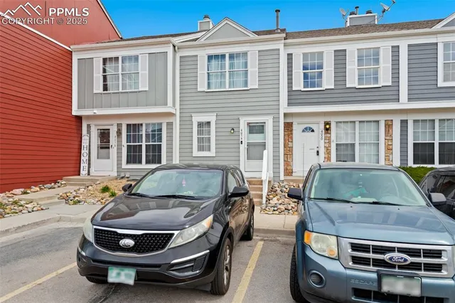 a car parked in front of a brick house