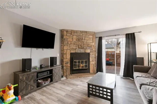 a living room with furniture a flat screen tv and a fireplace