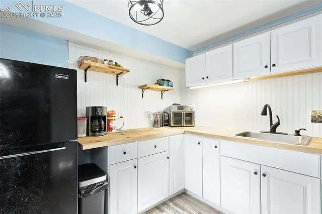 a kitchen with a sink stainless steel appliances and cabinets