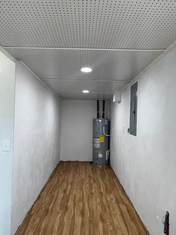 a view of a room with wooden floor