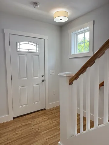 a view of entryway with wooden floor and stairs