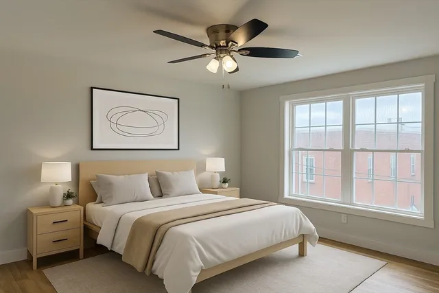 a bedroom with a large bed and a window