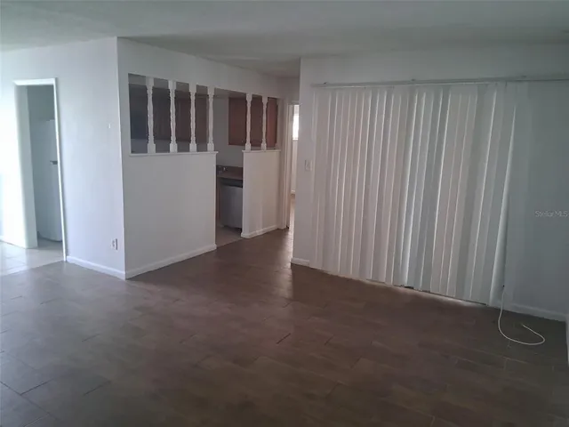 a view of empty room with floor to ceiling window