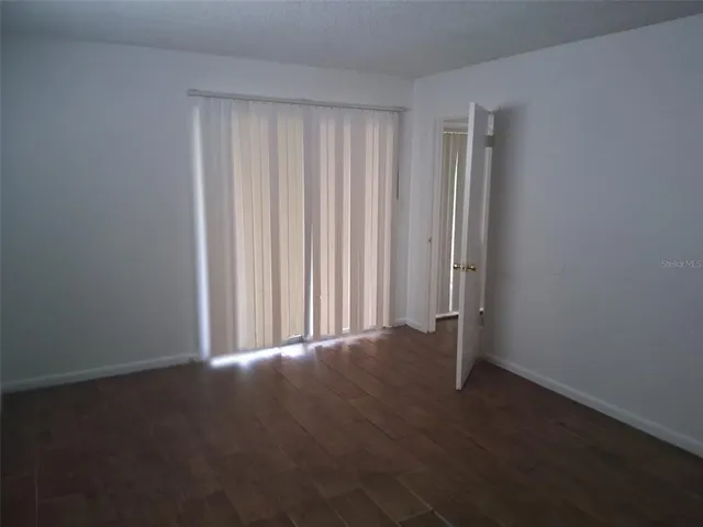 a view of a room with wooden floor
