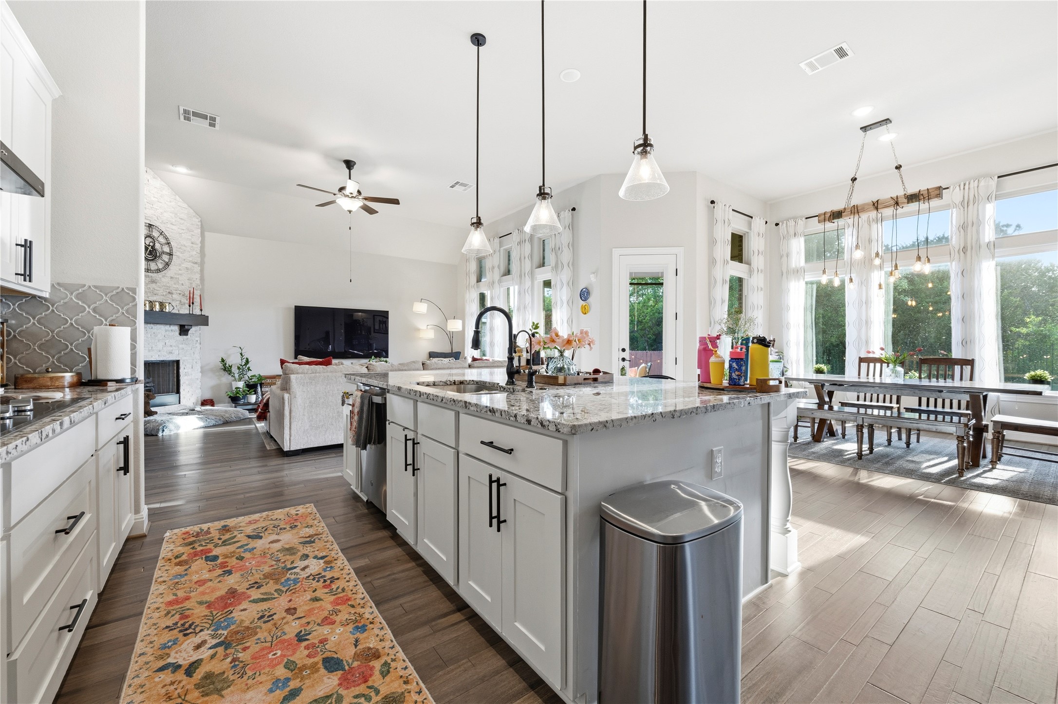 138 Rpd Spgs Cove Georgetown, TX 78628 - Photo 8 of 37 a kitchen with sink stove and white cabinets with wooden floor