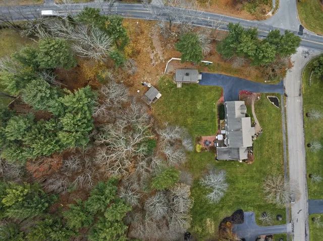 an aerial view of a house with a yard