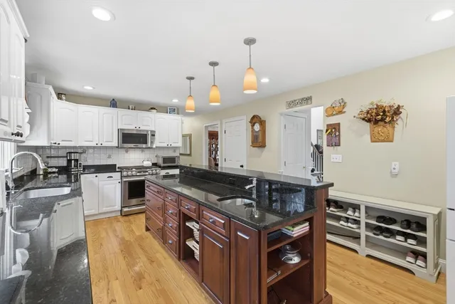 a kitchen with stainless steel appliances granite countertop a stove and a sink