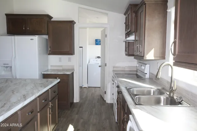 a kitchen with a sink stove and refrigerator