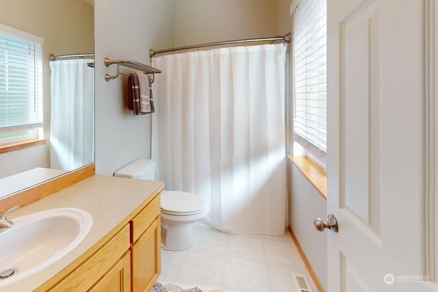 a view of a house with backyard sitting area and garden