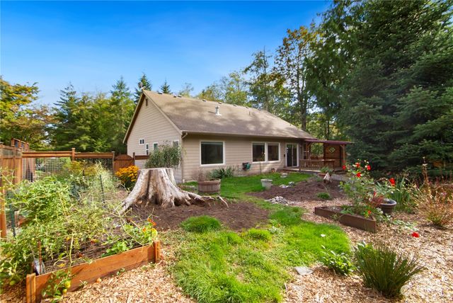 an aerial view of a house with a table & chairs
