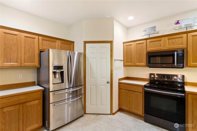 a kitchen with stainless steel appliances a sink stove and window