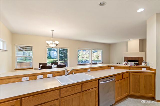 a view of a dining room with furniture a chandelier and wooden floor