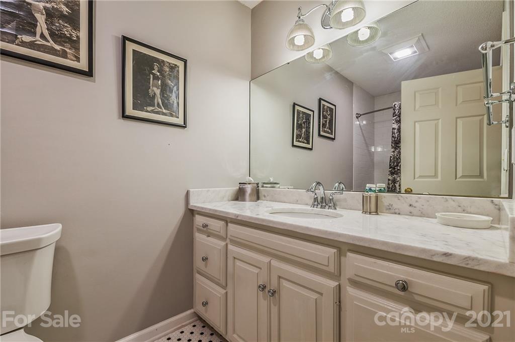 77 Chestnut Street, Unit 402 Tryon, NC 28782 - Photo 14 of 35 a bathroom with a sink a vanity and a toilet