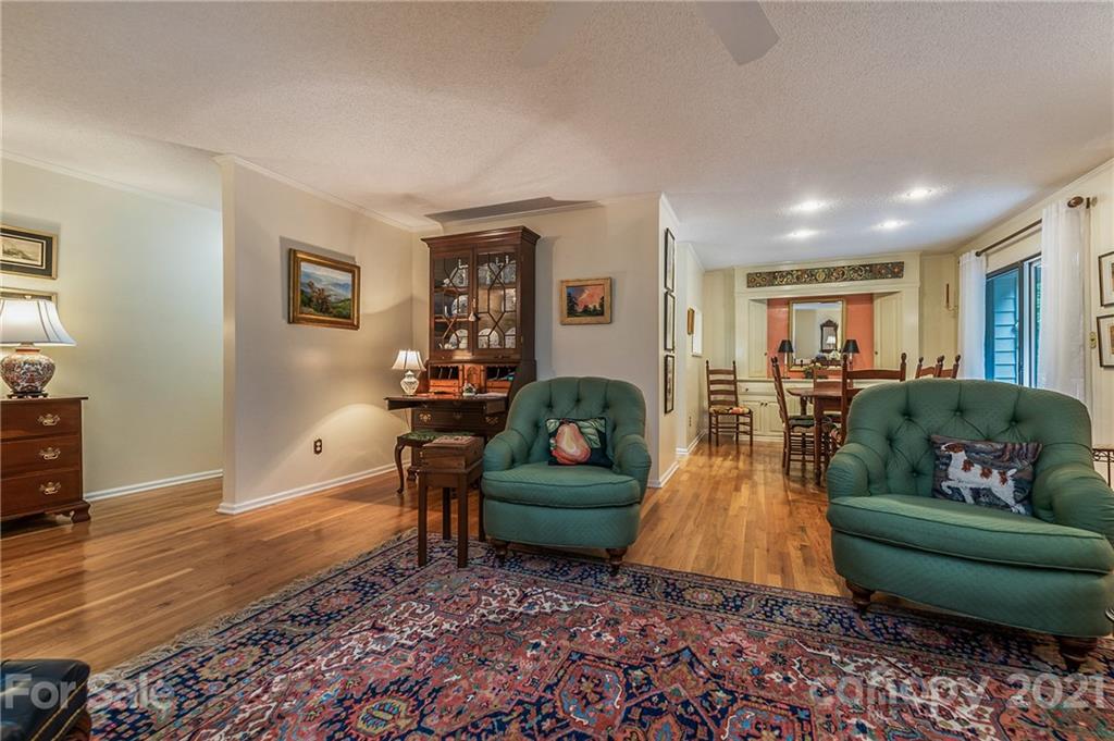77 Chestnut Street, Unit 402 Tryon, NC 28782 - Photo 5 of 35 a living room with furniture and a wooden floor