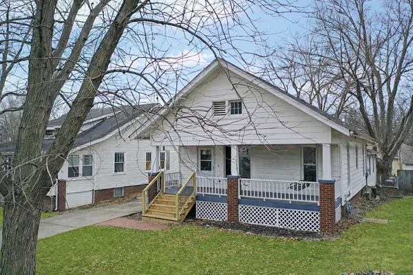 a view of a house with a yard and sitting area