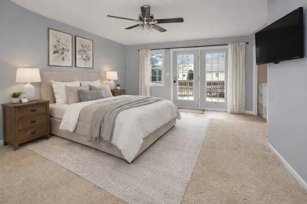 a spacious bedroom with a large bed and a flat screen tv