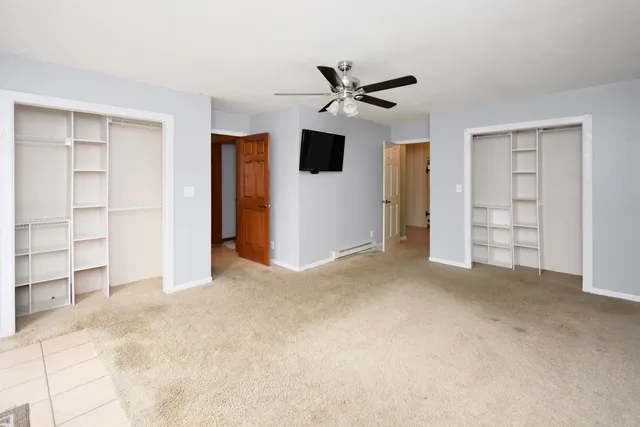 a view of empty room with cabinet and window