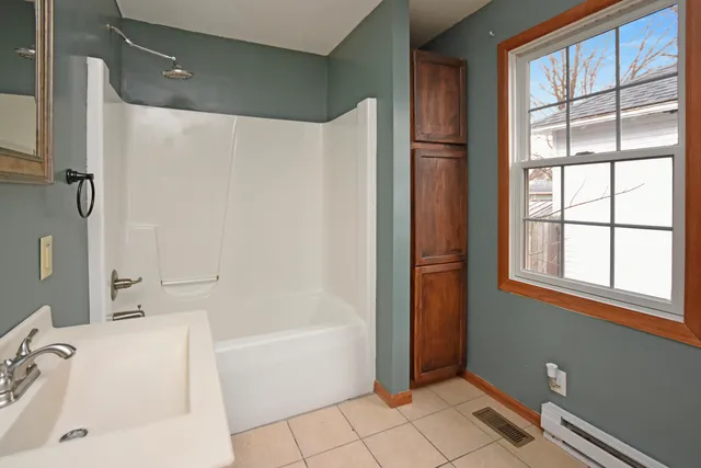 a bathroom with a bathtub and a shower