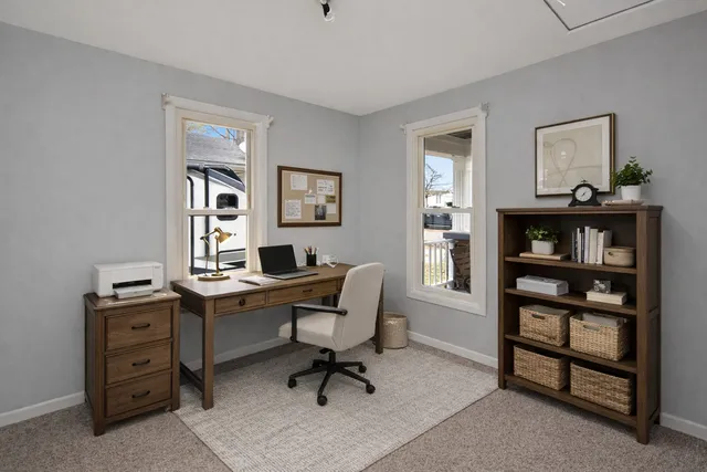 a view of a workspace with a window and shelf