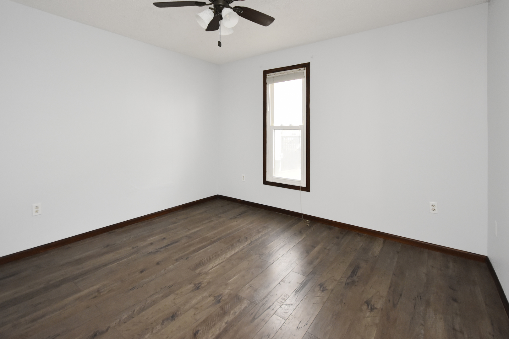 615 North Mulberry Street Clinton, IL 61727 - Photo 26 of 40 an empty room with wooden floor and windows
