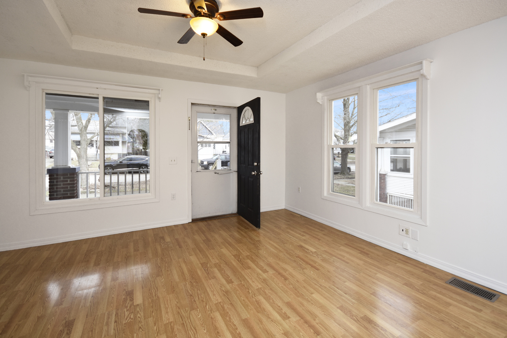 615 North Mulberry Street Clinton, IL 61727 - Photo 4 of 40 a view of an empty room with a window and wooden floor