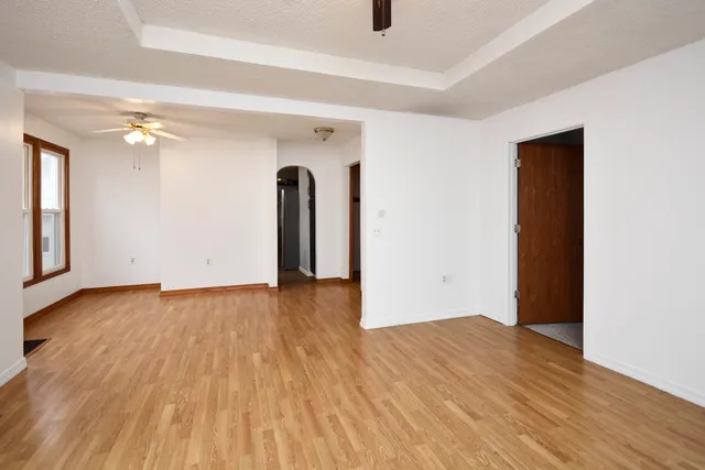 an empty room with wooden floor and closet
