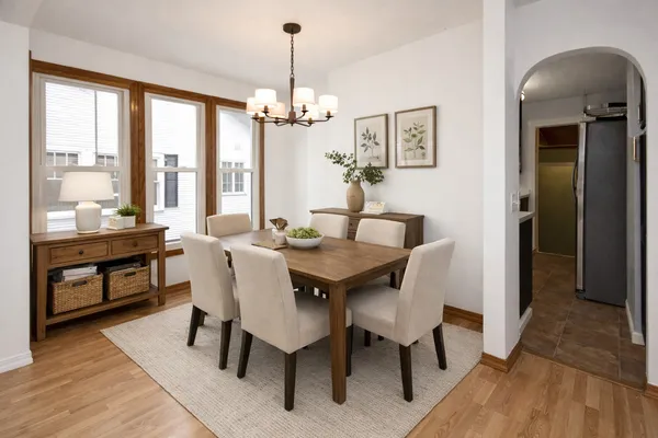 a view of a dining room with furniture window and wooden floor