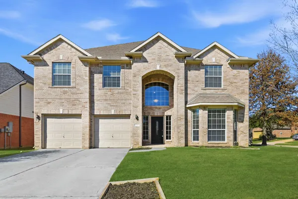 a front view of a house with a yard