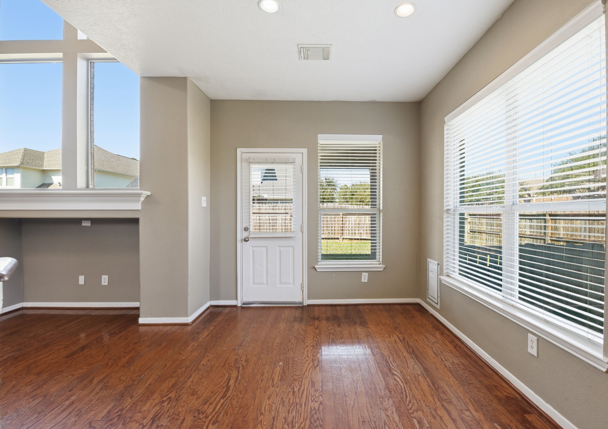 13902 Oneida Court Cypress, TX 77429 - Photo 15 of 48 an empty room with wooden floor and windows