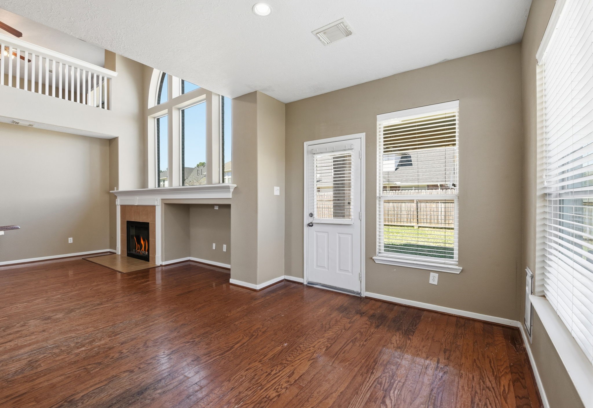 13902 Oneida Court Cypress, TX 77429 - Photo 16 of 48 an empty room with wooden floor and windows