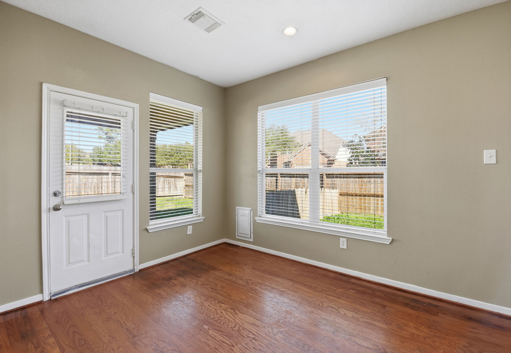 13902 Oneida Court Cypress, TX 77429 - Photo 17 of 48 an empty room with wooden floor and windows
