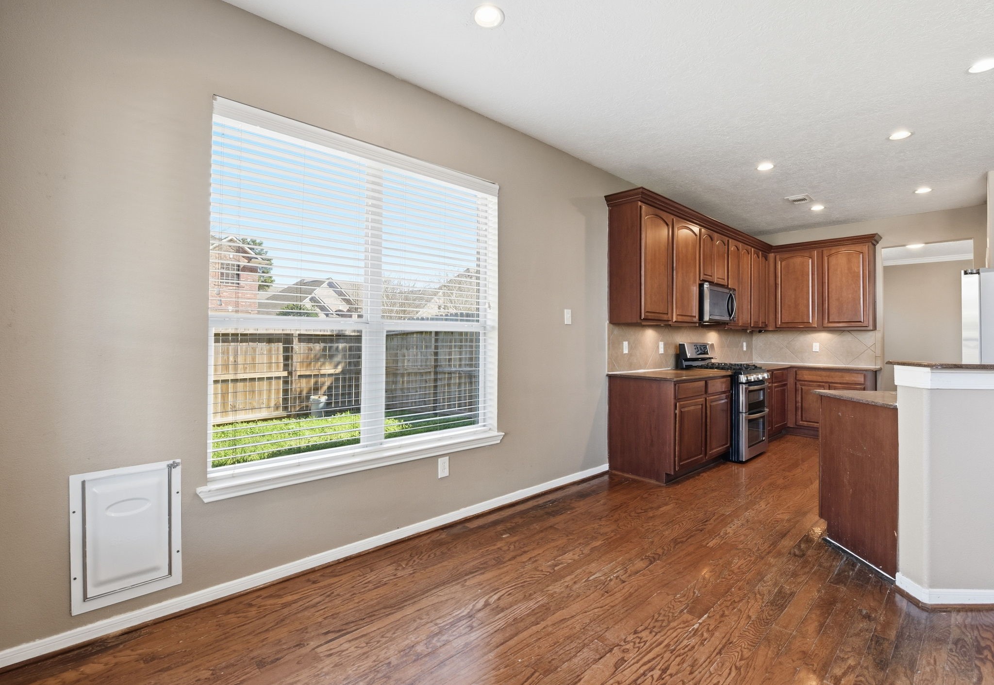 13902 Oneida Court Cypress, TX 77429 - Photo 18 of 48 a kitchen with stainless steel appliances granite countertop a stove a sink and a refrigerator